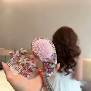 Cute acetate hair comb set featuring a massage brush and lovely horse design with colorful tassels.