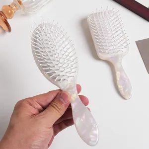 Pearl white air cushion hair brush detail showing smooth handle and soft bristles for daily care.