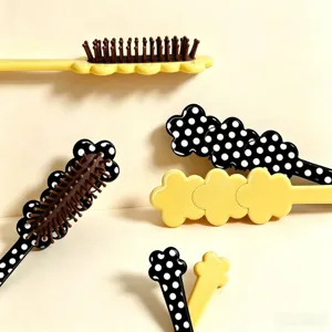 Cute flower polka dot hair brush massage comb, long handle cushion styling tool detail view.