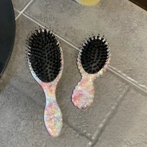 Pink acetate hairbrush set with cute marble texture, portable cushion massage comb for daily care.
