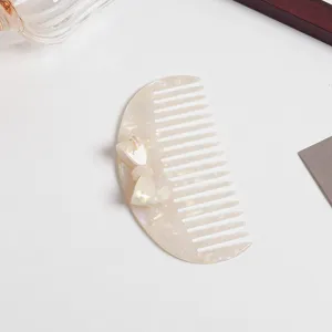 Acetate hair comb with elegant bow detail, vintage milky white pearl hair accessory for women.