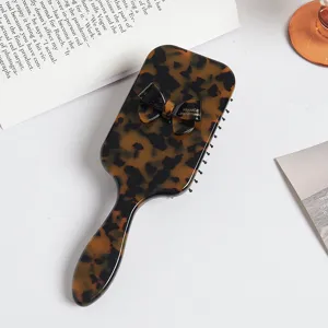 Tortoiseshell acetate paddle hair brush with chic bow design, anti-static daily detangling brush.