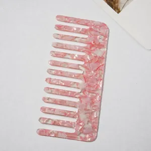 Acetate wide tooth hair comb with stylish pink marble pattern for anti-static daily hair styling detail.