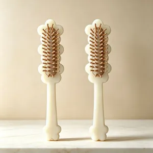 Detailed view of cream white acetate hair massage brush with wooden pins and air cushion base.