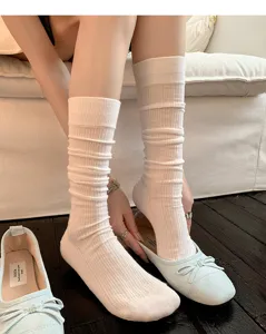 White cotton slouch socks for women, breathable calf length socks paired with flat shoes.