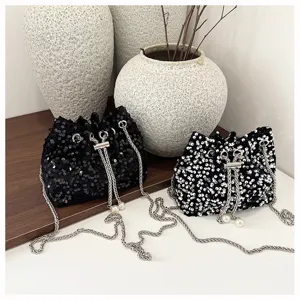 Stylish sequin bucket bag with metal chain strap, perfect for evening parties and daily wear.