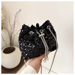 Black sequin bucket bag detail, sparkling finish, silver chain strap and pearl charm drawstring.