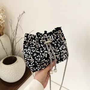 Black sequin bucket bag with metal chain and pearl charm, chic evening shoulder bag.