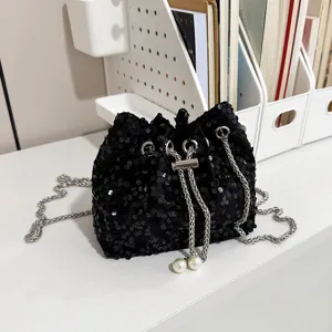 Black sequin bucket bag for women, sparkling evening shoulder bag with chain and pearl details.