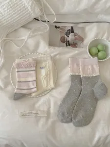 Close-up detail of sweet ballet style women socks featuring pearl and bow accents.