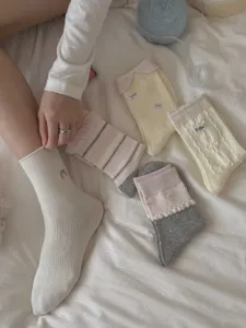Detailed view of sweet ballet style women socks featuring delicate pearl and bow decorations.