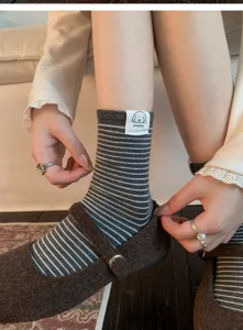 Cute striped mid-calf socks for women, featuring a sweet puppy label and soft cotton fabric.