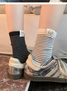 Detailed view of women's striped mid-calf socks with cute puppy label, premium cotton daily wear.
