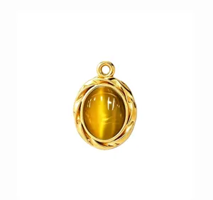 Detail shot of vintage oval cat eye stone pendant in gold stainless steel for DIY necklace.
