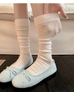 Detail view of white mesh calf socks with breathable ribbed design for summer ballet styling.