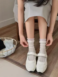 Detailed close-up of breathable mesh cotton slouch socks worn by model with casual shoes.