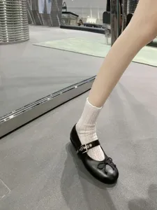 Black Mary Jane shoes with white lace ruffle socks, sweet JK style summer footwear detail.