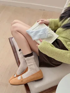 Comfortable women's mid-tube socks with cute ruffle edge design, soft cotton knit daily wear style.