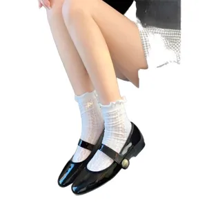 Black patent leather Mary Jane shoes paired with white lace frill socks, classic JK style.