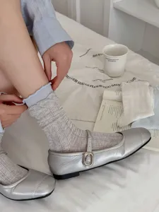Women spring summer mesh breathable mid tube socks with silver Mary Jane shoes close up detail
