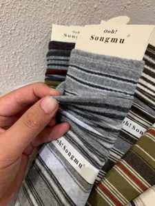 Detailed close-up shot showing the soft fabric texture and elastic stretch of the striped socks.