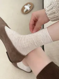 Korean style vertical ribbed mid-calf socks for women, soft solid color vintage daily wear detail.