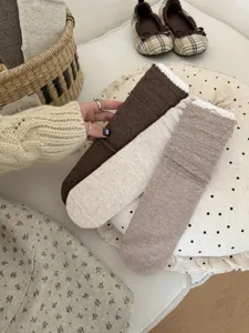 Detail view of women retro vintage style mid-tube socks featuring delicate lace hollow pattern.