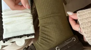 Olive green ribbed mid-calf socks with contrast ruffles, detailed knit texture for spring fashion.