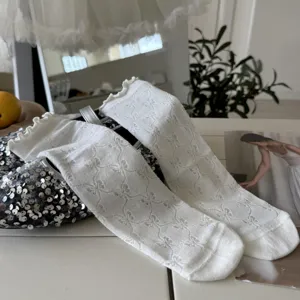 Detailed view of white women's ruffles bow mid-calf mesh socks, sweet spring summer style.