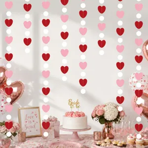 Hanging heart garland detail scene with romantic party decor and table setup for celebration.