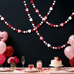 Valentine's day heart garland hanging decor scene showing red pink white paper hearts background.