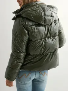 Detailed view of women's glossy hooded puffer jacket paired with stylish embroidered jeans.