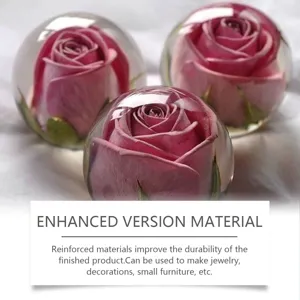 Crystal clear resin sphere with pink rose inside, durable DIY craft material for handmade decor.