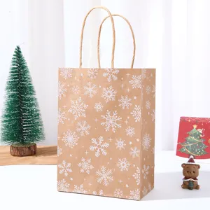 Kraft paper Christmas gift bag featuring white snowflake print, sturdy paper handles for holiday party.