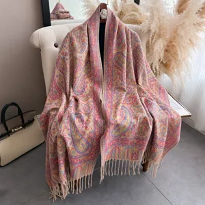 Vista dettagliata ed elegante dello scialle con frange jacquard paisley su una sedia.