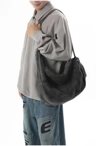 Detailed view of casual slouchy denim shoulder bag, soft large capacity hobo design.