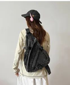 Back view detail showing retro washed denim crossbody sling bag with adjustable strap.