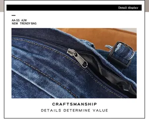 Close up view of the distressed denim bag showing fine zipper, durable buckle and detailed stitching craftsmanship.
