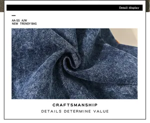 Denim bag detail view, retro washed fabric texture close-up, premium craftsmanship display.