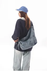 Casual denim crossbody bag detail view, showing vintage wash texture and daily wear.