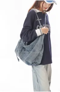 Casual denim shoulder bag detailed view, showing the spacious design and vintage wash texture.