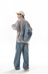 Casual denim backpack detail view, multifunctional student bag fabric and wear display.