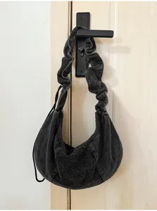 Detailed view of the dark grey denim hobo bag featuring stylish pleated strap and large capacity.