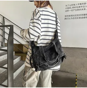 Detail shot of vintage washed denim crossbody bag, large capacity street style shoulder handbag.