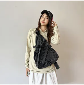 Retro washed denim chest bag detail showing the adjustable strap and multi-pocket design.