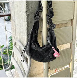 Casual denim hobo shoulder bag with stylish pleated strap and spacious design detail view