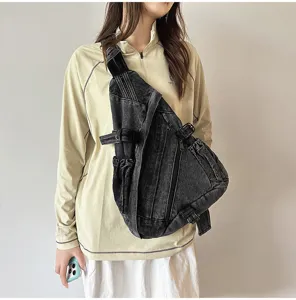 Vintage washed denim sling bag detail, large capacity crossbody style with zipper pocket.