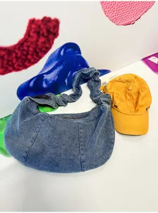 Casual denim shoulder bag for women, stylish hobo purse with ruched handle and spacious capacity.
