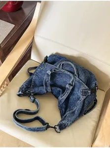 Vintage washed denim shoulder bag detail, large capacity crossbody bag with black buckles.