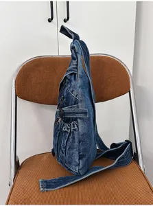 Vintage washed denim sling bag for women, casual crossbody chest bag with multi pockets.